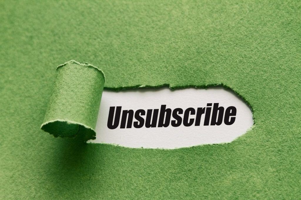 the word "unsubscribe" seen under a green piece of paper
