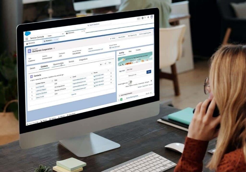 A woman using the CRM system on a desktop computer