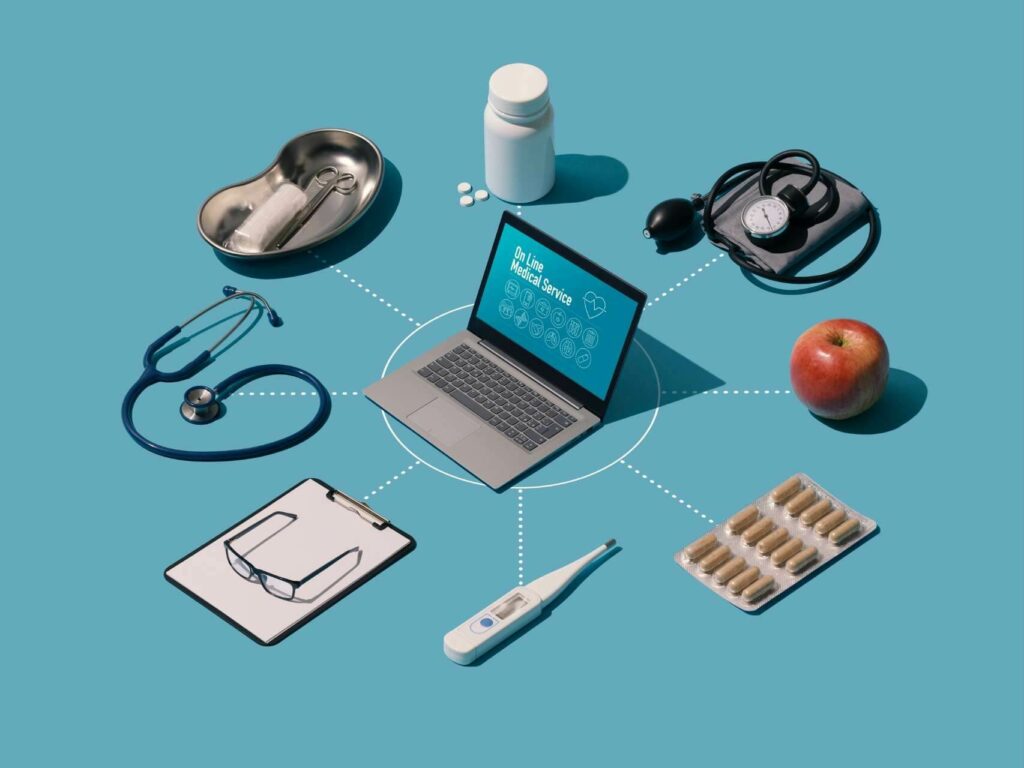 Graphic showing a laptop and several surrounding attributes associated with health care: stethoscope, blood pressure monitor, medicine blister, thermometer and others