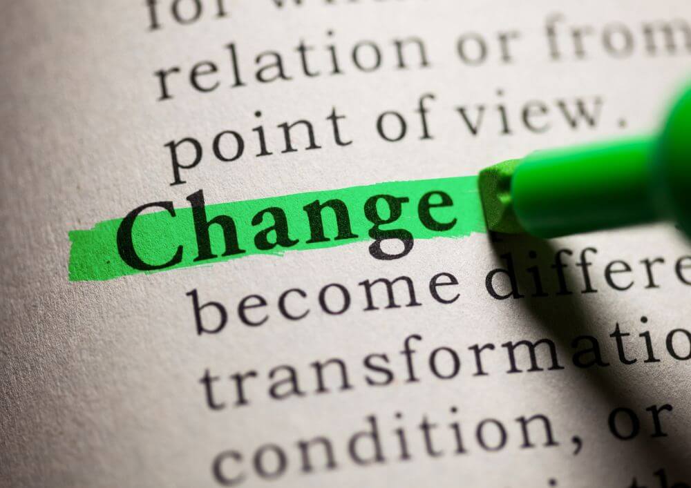A close-up of the definition of the word 'change', which is highlighted in green highlighter 